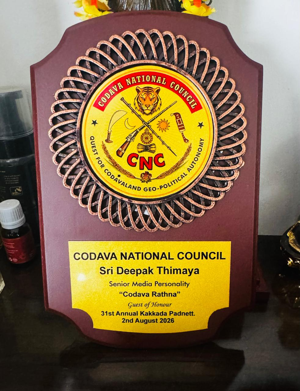 Codava Rathna award plaque presented to Deepak Thimaya